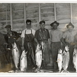 Fishermen holding a sample of the six tons of salmon caught